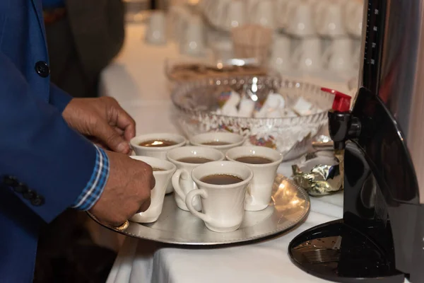Brewed coffee stacked on a tray to bring back to the family to drink at the banquet dinner party.