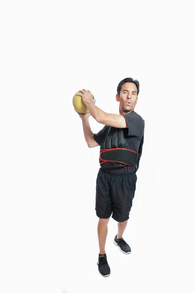 Medicine ball chops in weighted vest — Stock Photo, Image