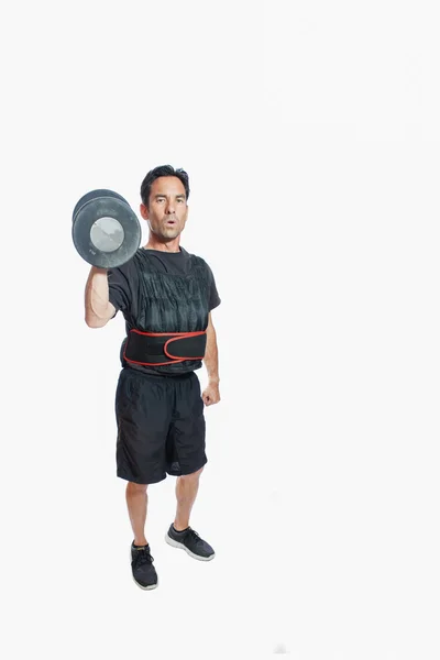 Single standing dumbbell press in weighted vest — Stock Photo, Image