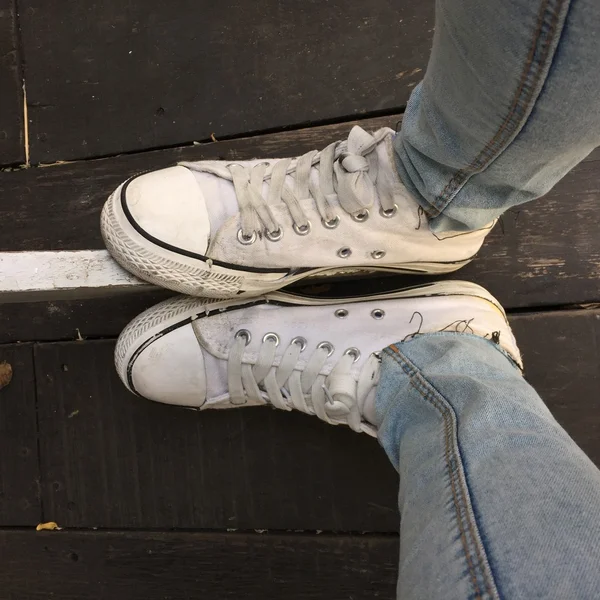 Fashion hipster cool woman with white sneakers, soft vintage toned colors great for any use. — Stock Photo, Image