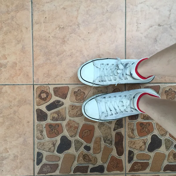 Взуття для білих кросівок, що ходять на брудному бетоні зверху — стокове фото