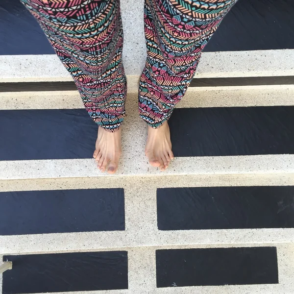 Walking upstairs: close-up view of woman\'s feet