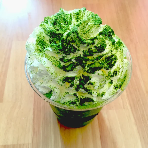 Green tea smoothie and frappe on wood table