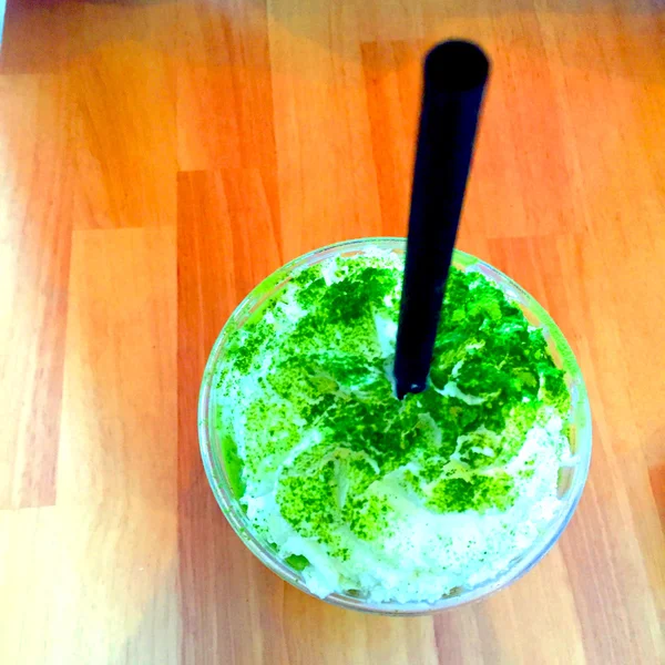 Green tea smoothie and frappe on wood table