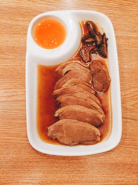 Roasted duck with pear,marinated in sauce on wood background — Stock Photo, Image