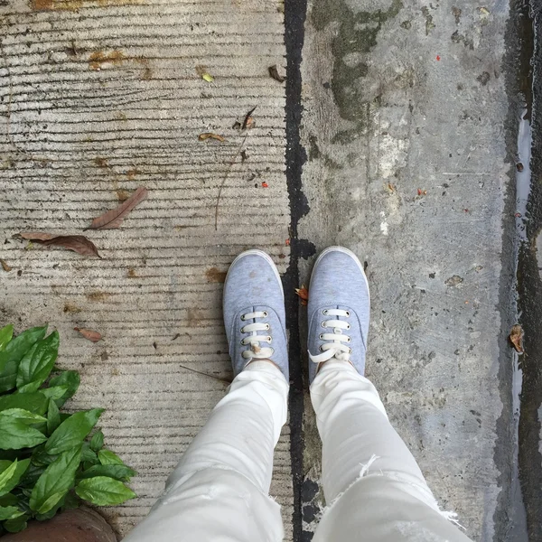 Gray Sneakers walking on floor — Stock Photo, Image