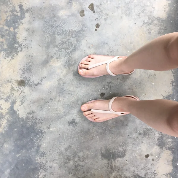 Les jambes et les pieds de la femme se tiennent sur le sol — Photo