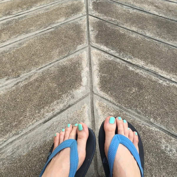 Bare Woman Feet on Ground or Floor. Top View