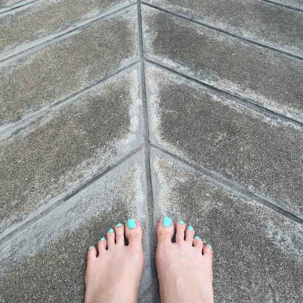 Bare Woman Feet on Ground or Floor. Top View