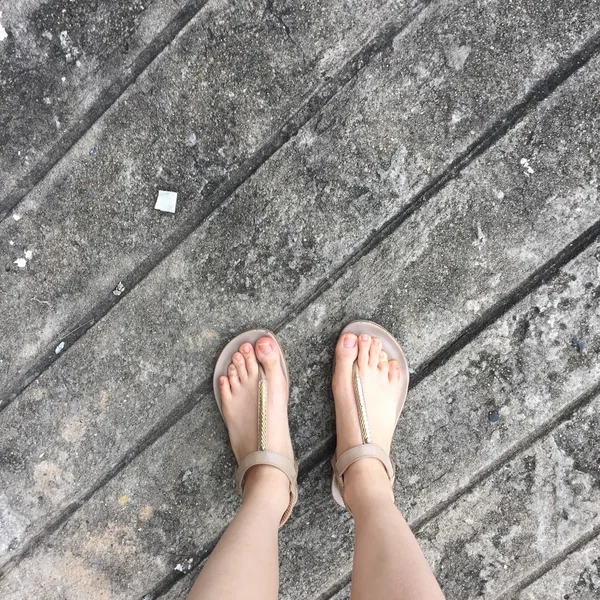 Woman's Gold Flipflop on Ground or Floor. Top View — Stock Photo, Image