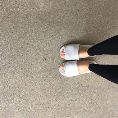 Ayakta bir kadının beyaz tüylü terlikler yakın çekim