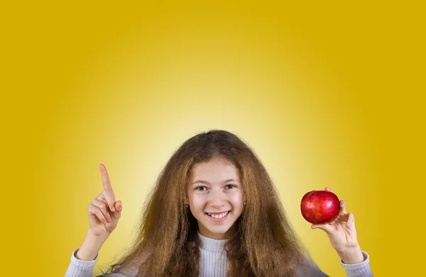 Smiling little girl holding an red apple — Stock Photo, Image