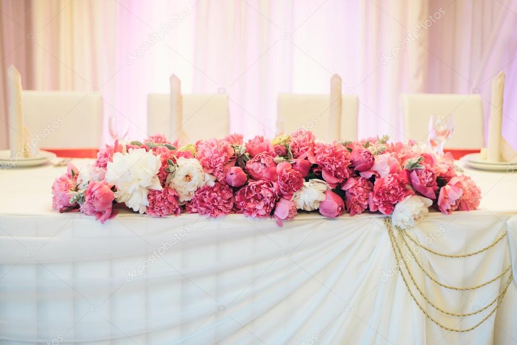 Floral arrangement of peonies on the table