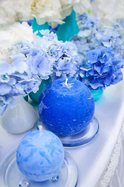 Blue hydrangeas and candles — Stock Photo, Image