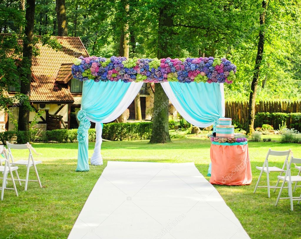 Beautiful wedding arch with flowers in garden