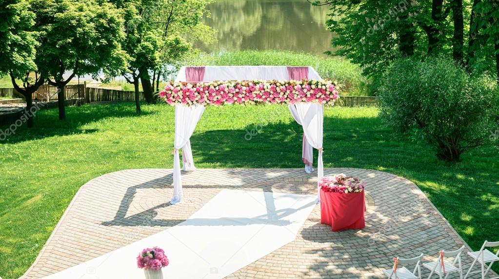Beautiful wedding arch with flowers is ready for ceremony