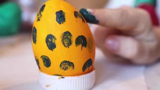 Καλό Πάσχα. Κοριτσάκι βάφει πασχαλινά αυγά και ετοιμάζεται για τις διακοπές του Πάσχα. Χρωματισμός αυγών. Τρόπος ζωής — Αρχείο Βίντεο