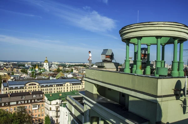 Um homem no topo de Skyscrapeer olhando para a cidade — Fotografia de Stock