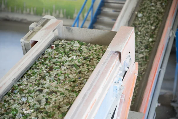 Glass waste in recycling facility. Glass particles in a machine — Stock Photo, Image