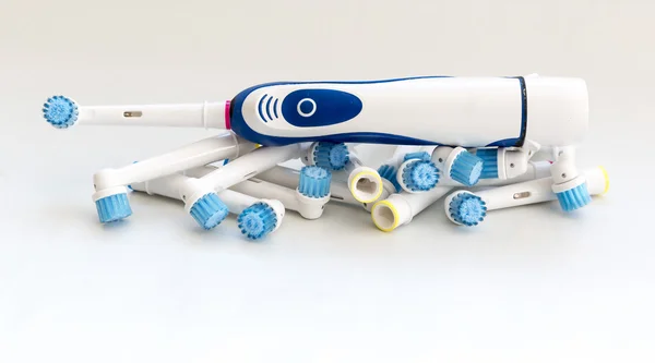 Electronic toothbrush with toothbrush heads on white — Stock Photo, Image