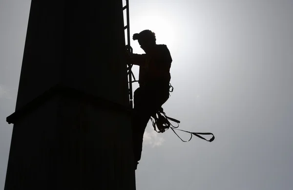 Cabin lift pillar silhouette and rescuer — Stock Photo, Image