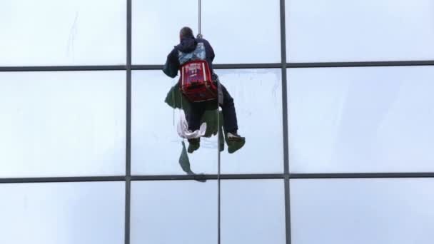 Sanitation worker cleaning glass facade hotel — Stock Video