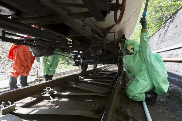 Toxic chemicals acids emergency team under tank — Stock Photo, Image