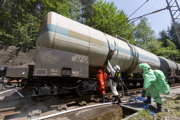 Toxic chemicals acids emergency team near train — Stock Photo, Image