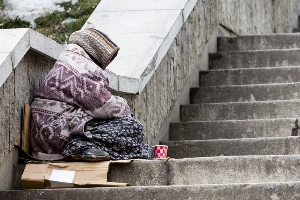 Homeless gypsy woman begging for money alone — Stock Photo, Image