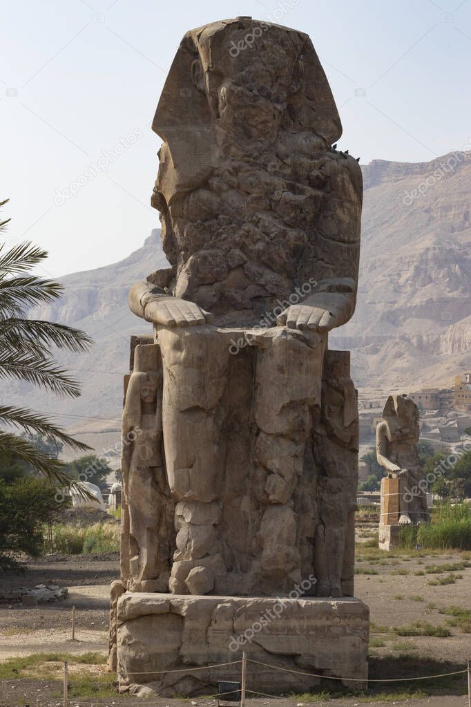 Colossi of Memnon - the ancient guardians of the temple of Amenhotep III at the entrance to the nonexistent ruined burial temple, the city of the dead Luxor