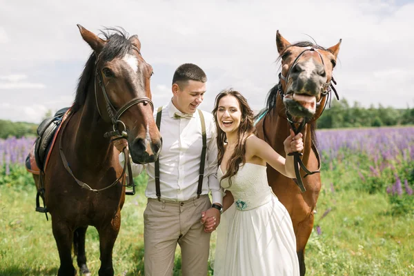 Šťastný Svatební pár s koňmi — Stock fotografie