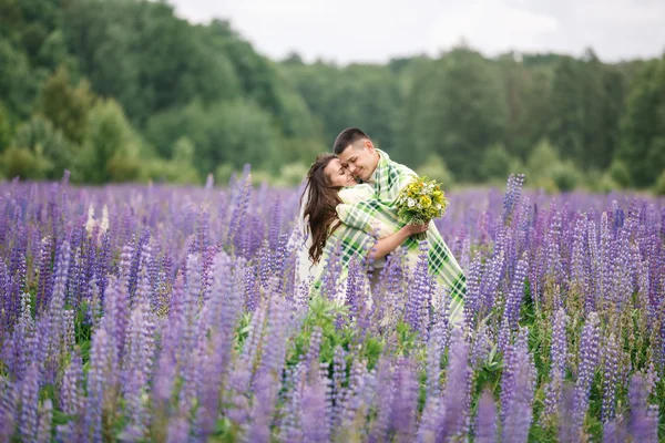 Happy wedding couple in lupin — Stock Photo, Image