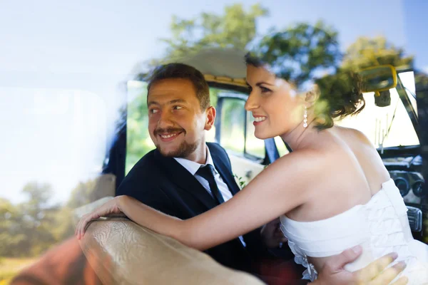 A wedding couple in old car — Stock Photo, Image
