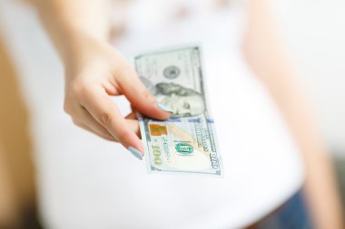 Hand of woman giving money
