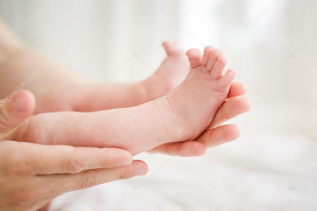 Baby legs in mother hands