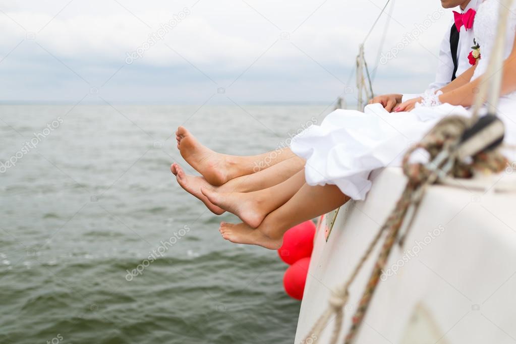 Legs of newlyweds on a yacht