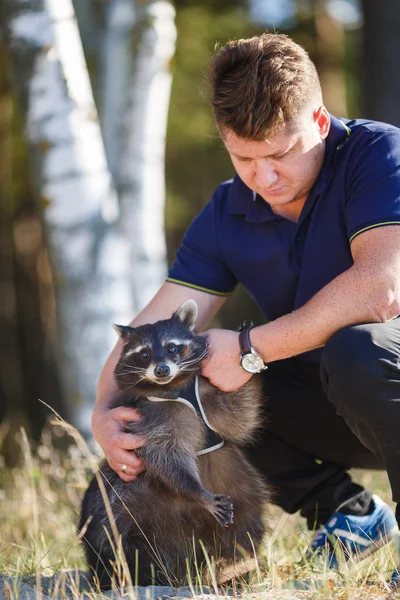 Man with raccoon