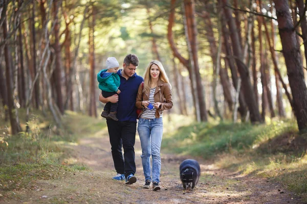 Happy family with raccoon — Stock Photo, Image