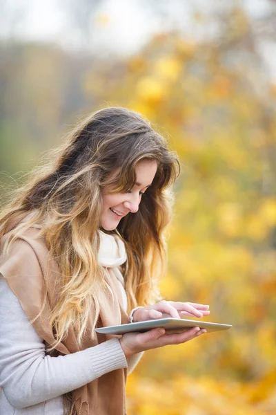 Chica con la tableta en otoño — Foto de Stock