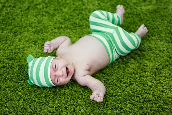 Crying baby on the soft rug — Stock Photo, Image