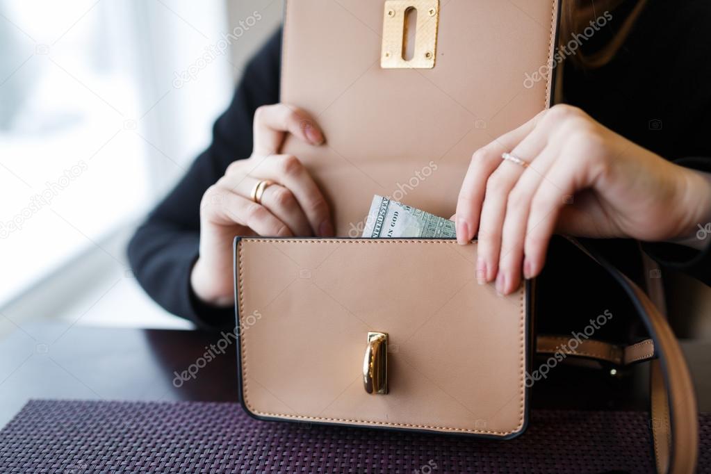 Woman holding a one hundred dollar bill