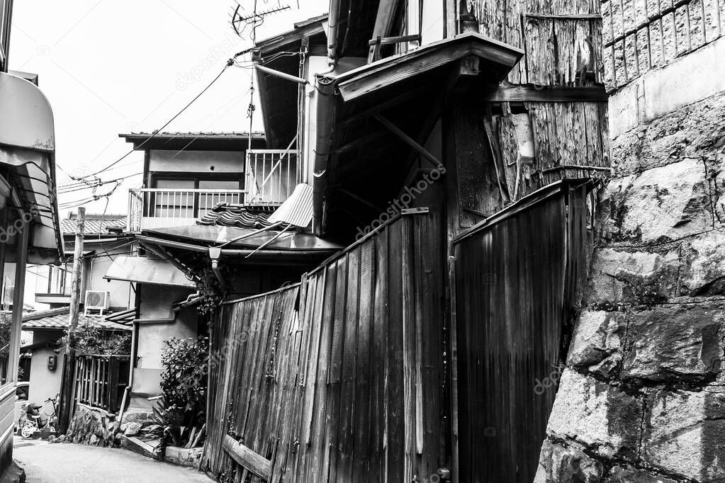 Old ancient traditional street with wooden houses in Kyoto, Japan. Black and white image