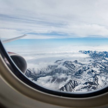 View of the Kamchatka mountains from the airplane porthole. clipart