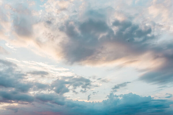 Blue sky with a pastel colored. Soft texture of fluffy clouds.