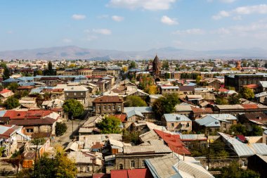 Gyumri şehrini, Ermenistan 'ı kilisenin kubbesiyle dağların arka planına bakın.