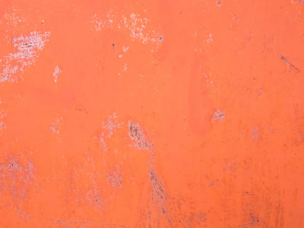 Orange painted cement wall with scratches and stains. Abstract grunge texture background. Copy space, empty template for text