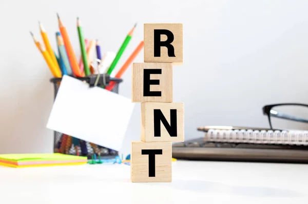 Rent text on wooden blocks. The concept of renting housing. Rental. Saving money
