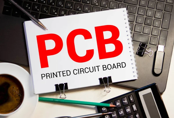 PCB Printed Circuit Board - handwriting on paper with cup of coffee and pen, acronym business concept