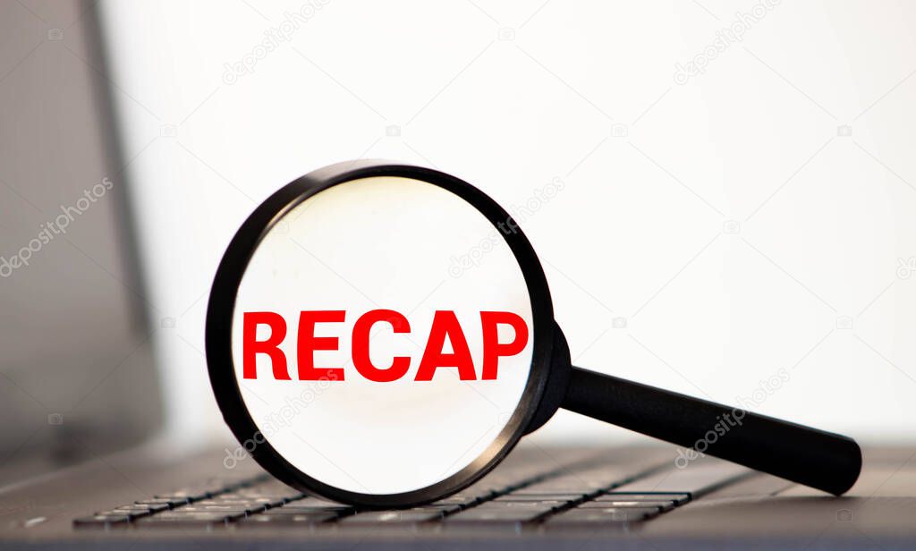 Recap word inscription through magnifying glass on financial documents charts, recap in finance, summary concept.