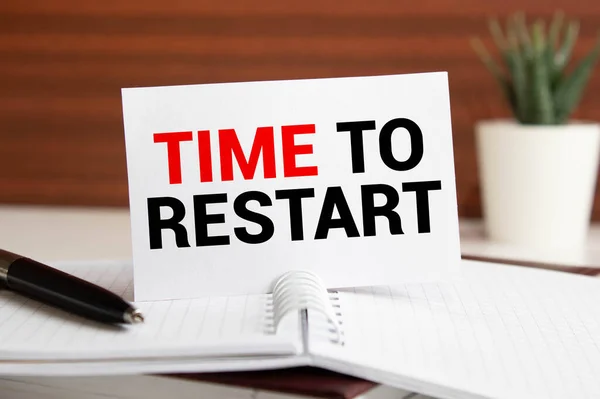 businesswoman holding a black paper plate with text TIME TO RESTART.